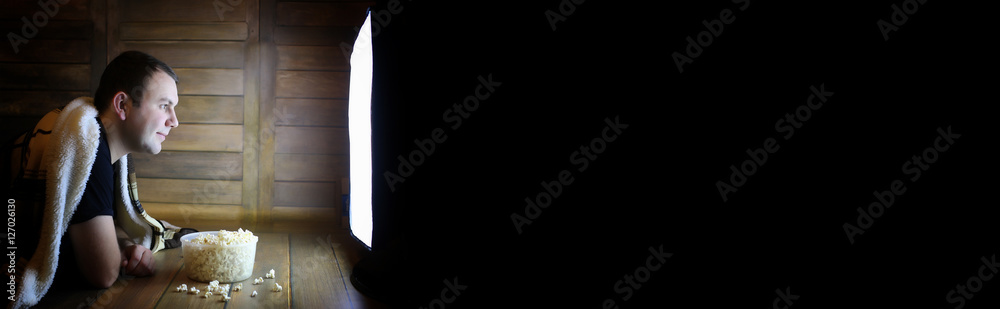 Fototapeta premium man watching television at home on the floor