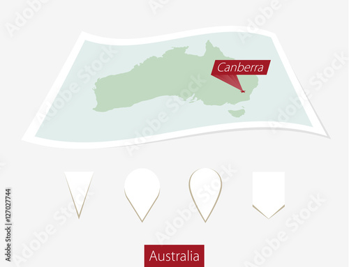 Curved paper map of Australia with capital Canberra on Gray Background.
