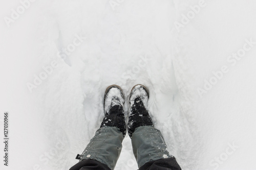 Top view of feet in boots and gaiters snow protection in the sno