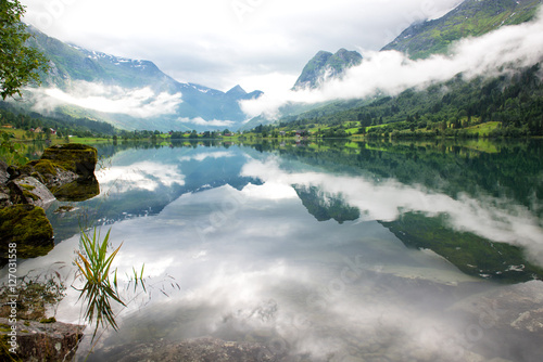 Rural lake landscape with mountains and clouds, Norway