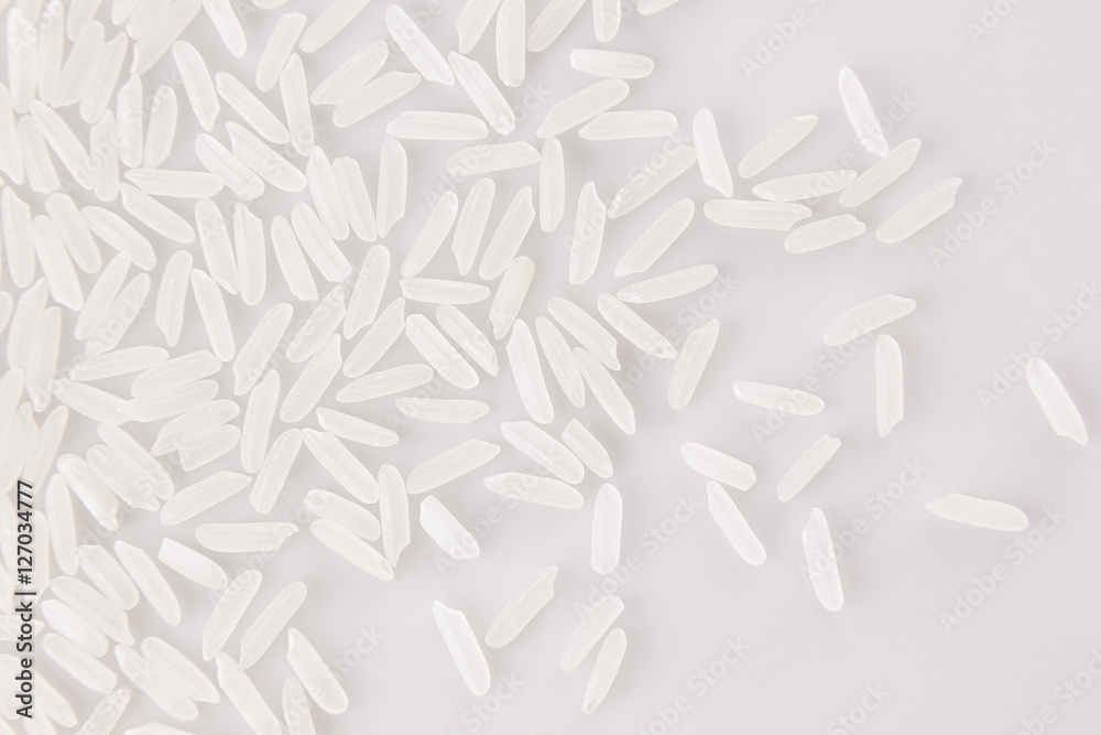 White jasmine rice close-up on white background. Decorative ending of rice. White jasmine rice close-up on white background. Decorative ending of rice.