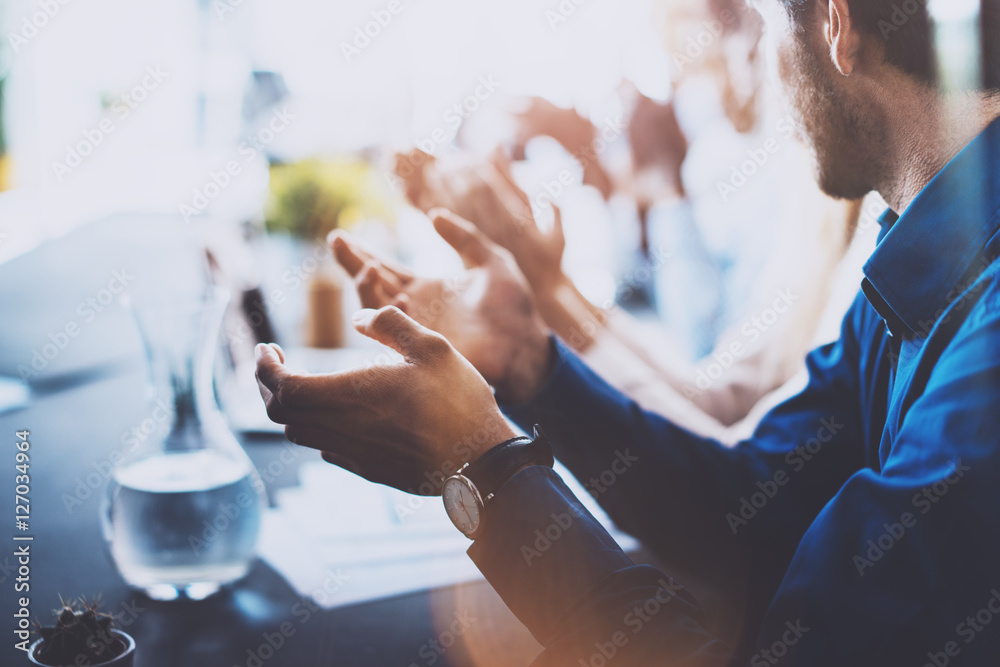 Close up view of young business partners applauding to reporter after listening speech at seminar. Professional education, work meeting, presentation or coaching concept.Horizontal,blurred background. Close up view of young business partners applauding to reporter after listening speech at seminar. Professional education, work meeting, presentation or coaching concept.Horizontal,blurred background.