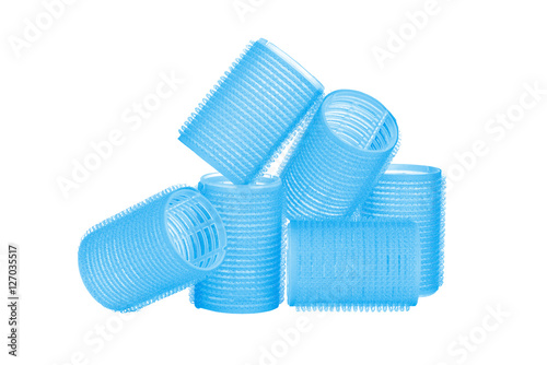Set of six blue hair curlers isolated on white background