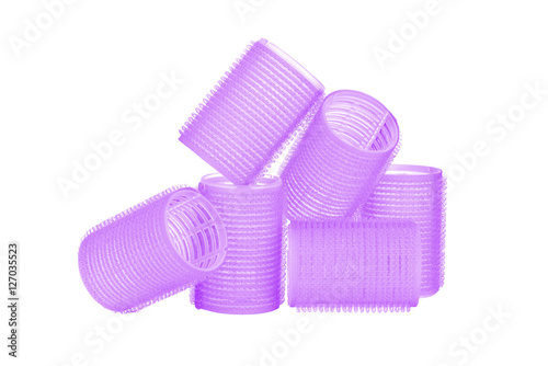 Set of six purple hair curlers isolated on white background