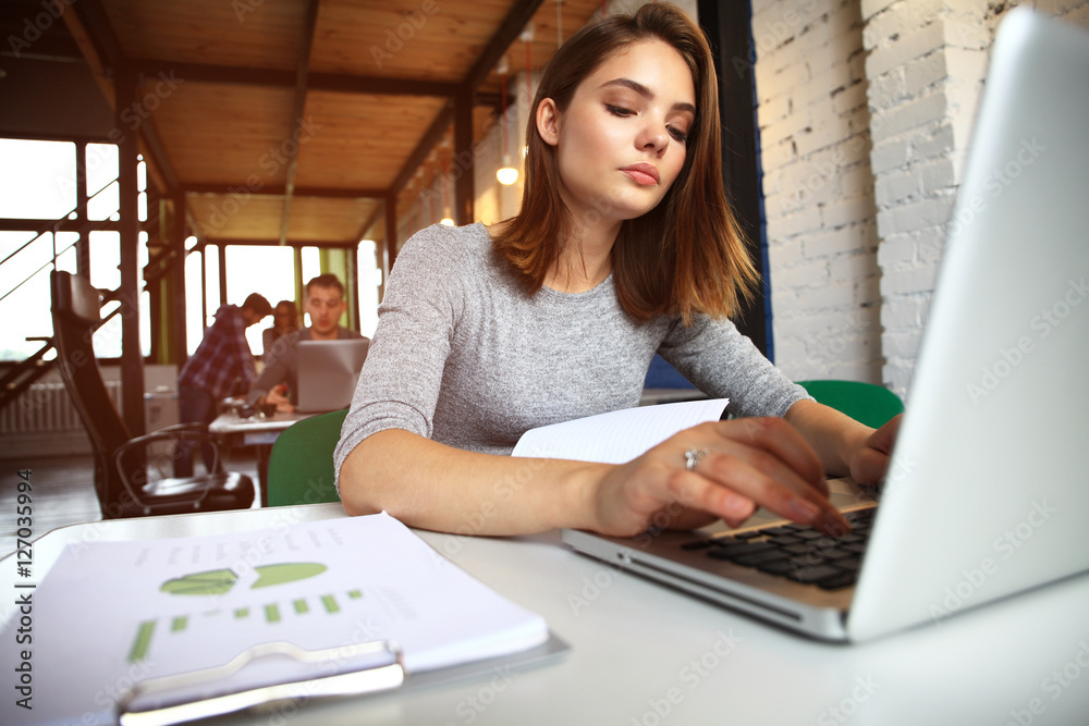 Photo woman working with new startup project in modern loft. Generic design notebook on wood table Photo woman working with new startup project in modern loft. Generic design notebook on wood table