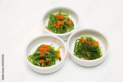  portion of fresh wakame seaweed on a white background