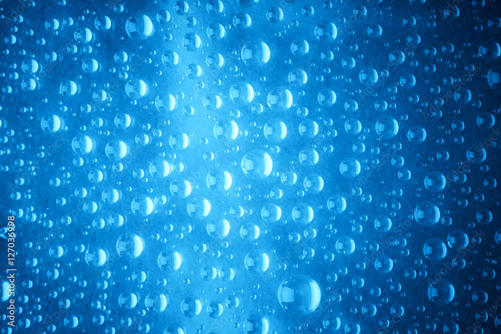 Blue water drops of on treat water-repellent surface in macro lens shot small-DOF for screen wallpapers