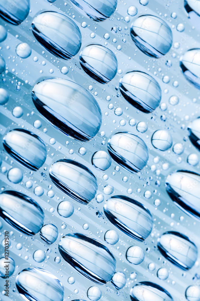 Blue water drops of on treat water-repellent surface in macro lens shot small-DOF for screen wallpapers Blue water drops of on treat water-repellent surface in macro lens shot small-DOF for screen wallpapers