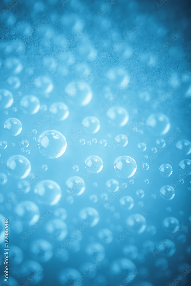 Blue water drops of on treat water-repellent surface in macro lens shot small-DOF for screen wallpapers
