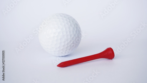 golf ball and red wooden golf tees on white background, sport time