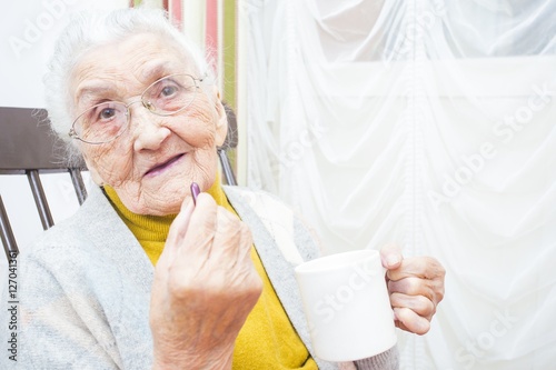 Elderly lady taking medication photo