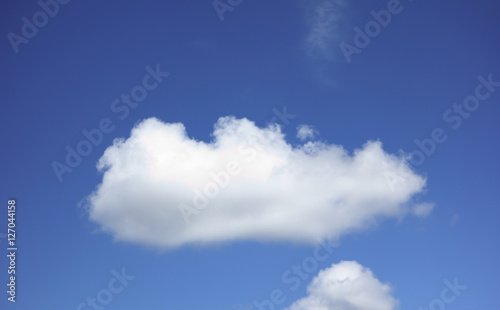 the white clouds floating on a background of blue sky