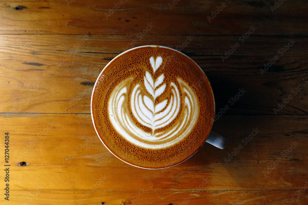 cup of latte art coffee on wooden background cup of latte art coffee on wooden background