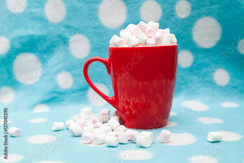 marshmallow in a red cup on a blue background