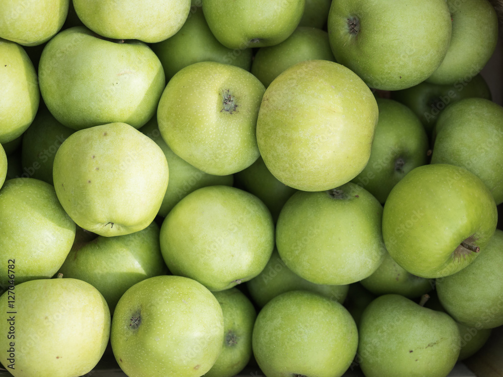 Background of green apples close up. Green apples pattern on sale at the market. Background of green apples close up. Green apples pattern on sale at the market.