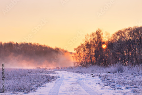 Winter misty colorful sunrise. Rural foggy and frosty scene. © NemanTraveler