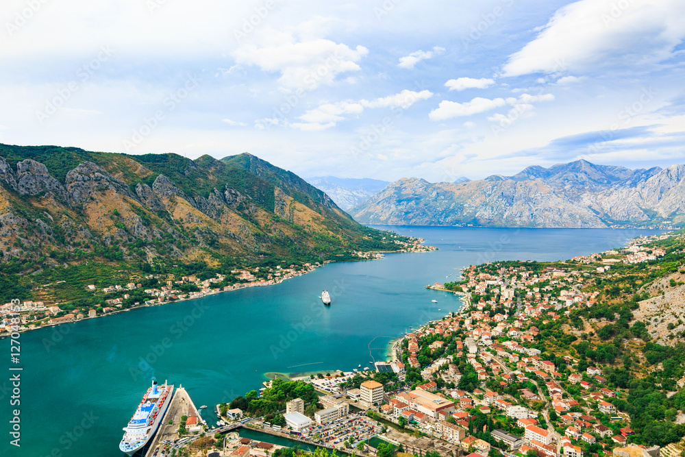 Panoramic view of cityscape, old town, sea and old mediterranean port with cruise ship in Bay of Kotor, Montenegro.