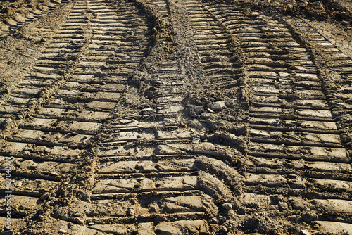 Tractor tracks in soil at housing construction site.