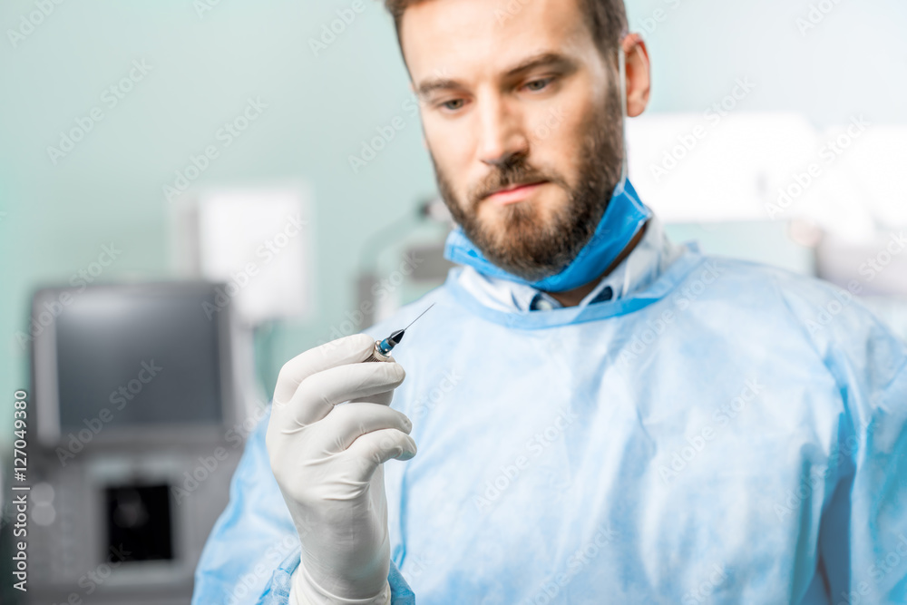 Surgeon holding small surgical scissors for eye operation in the