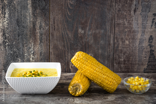 Corn soup in bowl on wooden background