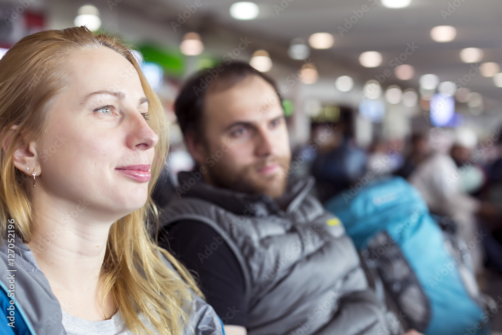 Man and woman sitting at airport terminal