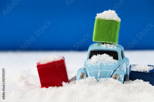 vintage car blue and gift box on the snow.