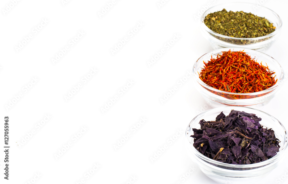 Basil, Saffron, Mint in a Glass Bowl on a White Basil, Saffron, Mint in a Glass Bowl on a White