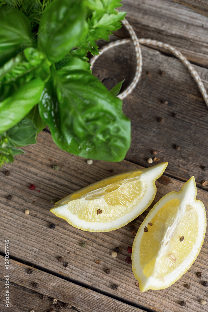 Top view of lemon slices, pepper and herbal bunch. Selective foc Top view of lemon slices, pepper and herbal bunch. Selective foc