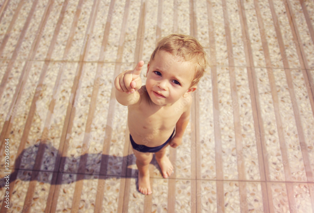 Fototapeta premium Boy in swimwear pointing