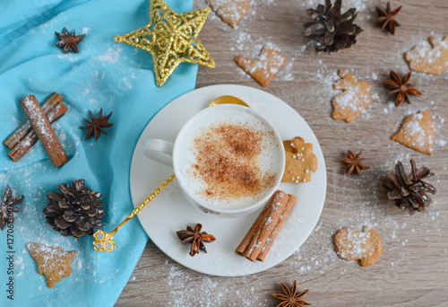 Cup of cappuccino with christmas decorations on wooden table