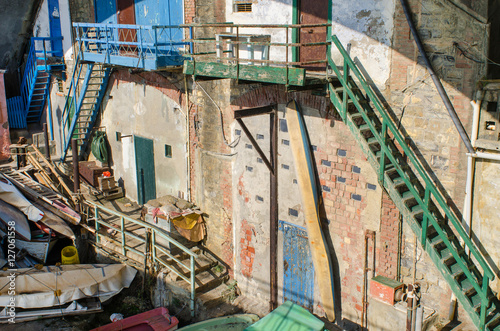 An interesting grungy old place under the seaside promenade in Genoa Nervi, Italy, with different boats and sailing equipment