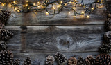 Christmas light with fir cones for natural frame, copy space