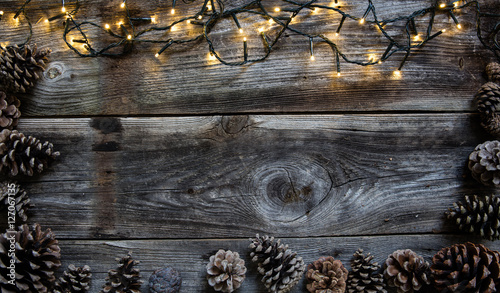 Christmas light with fir cones for natural frame, copy space