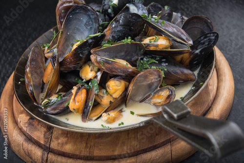 seafood mussels on pan with cream sauce