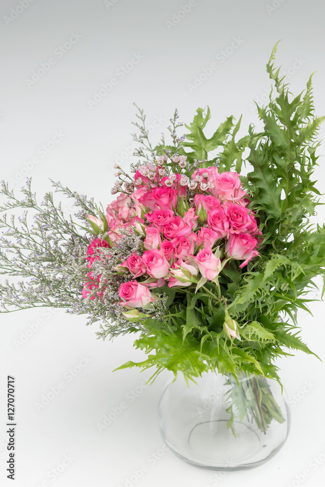 bouquet of flower on glass vase on white isolated background