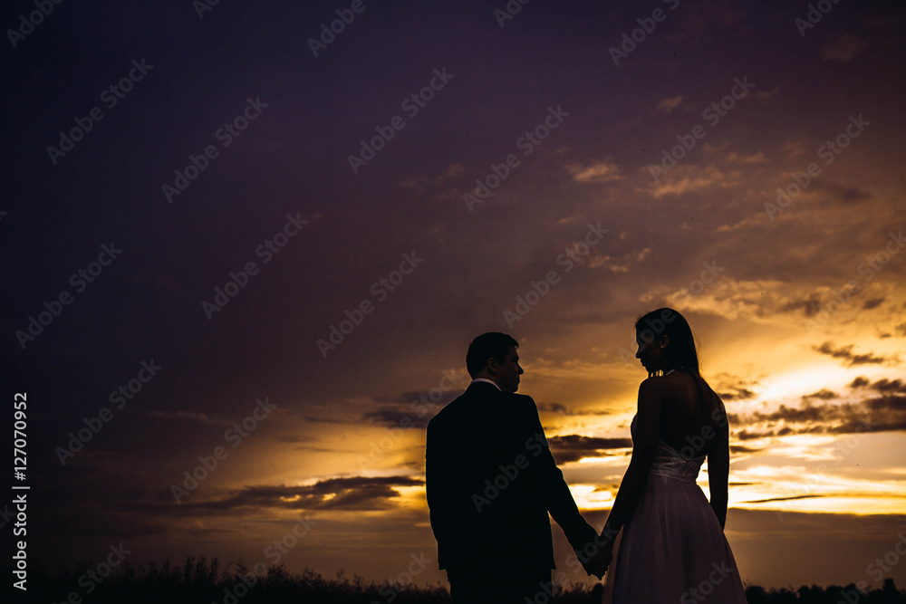 beautiful and young bride and groom standing standing together a
