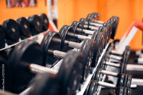 Image of iron dumbbells in two rows