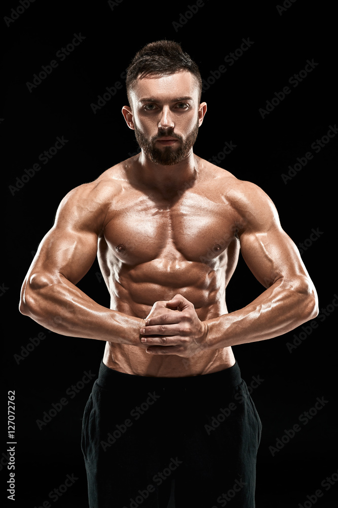 very muscular man posing with naked torso in studio