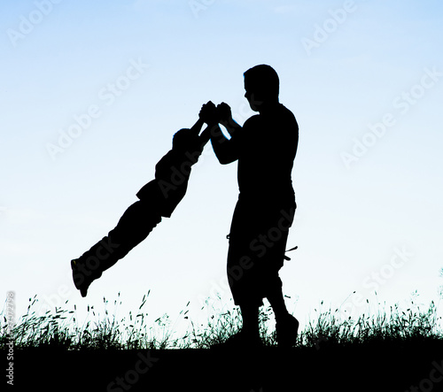 Silhouettes of a happy family of the father and the child