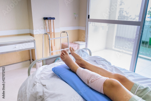 Patient laying in a hospital bed her a  broken leg