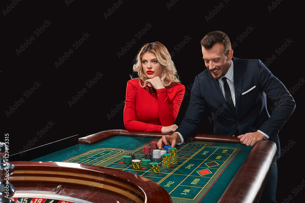 Couple playing roulette wins at the casino. Couple playing roulette wins at the casino.