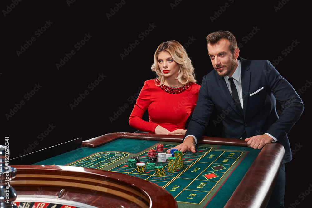 Couple playing roulette wins at the casino. Couple playing roulette wins at the casino.