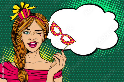 Pop art face. Young sexy woman with gift box on her head and carnival mask in her hand smiles and winks with speech bubble. Vector illustration in retro comic style. Holiday party invitation poster.