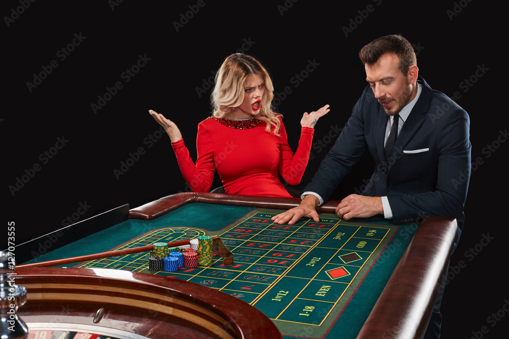 Couple playing roulette wins at the casino. Couple playing roulette wins at the casino.