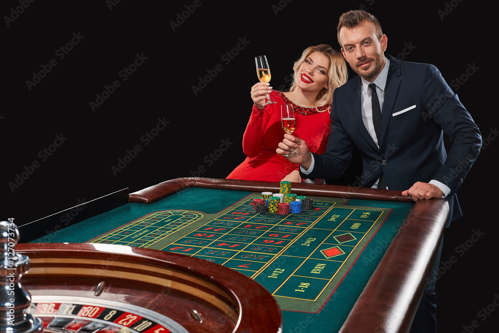 Couple playing roulette wins at the casino. Couple playing roulette wins at the casino.