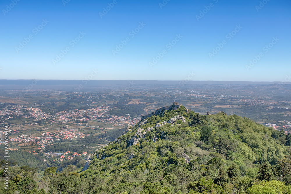 The Castle of the Moors is a hilltop medieval castle in Sintra. View of the castle from the palace of Pena. Portugal