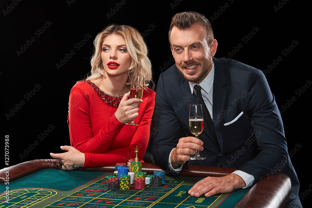 Couple playing roulette wins at the casino. Couple playing roulette wins at the casino.