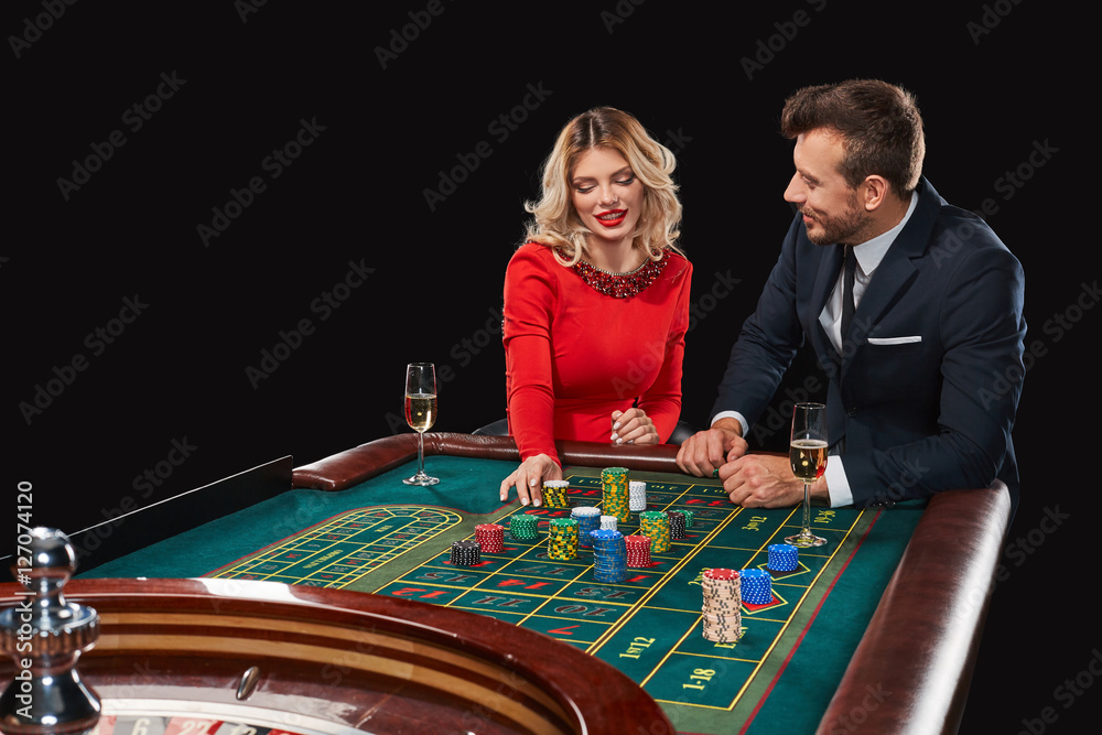 Couple playing roulette wins at the casino. Couple playing roulette wins at the casino.