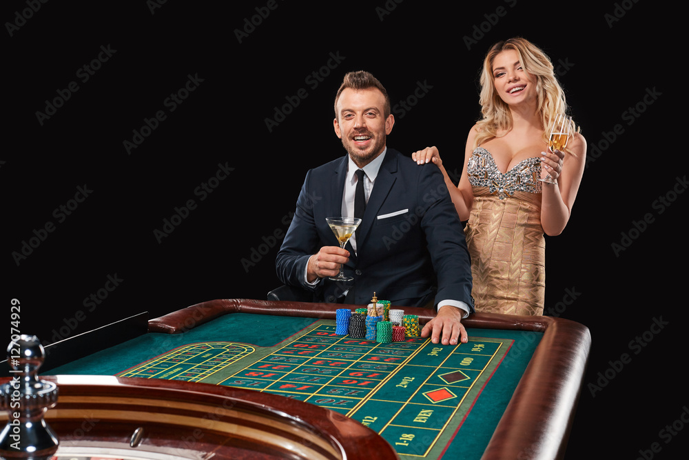 Couple playing roulette wins at the casino.