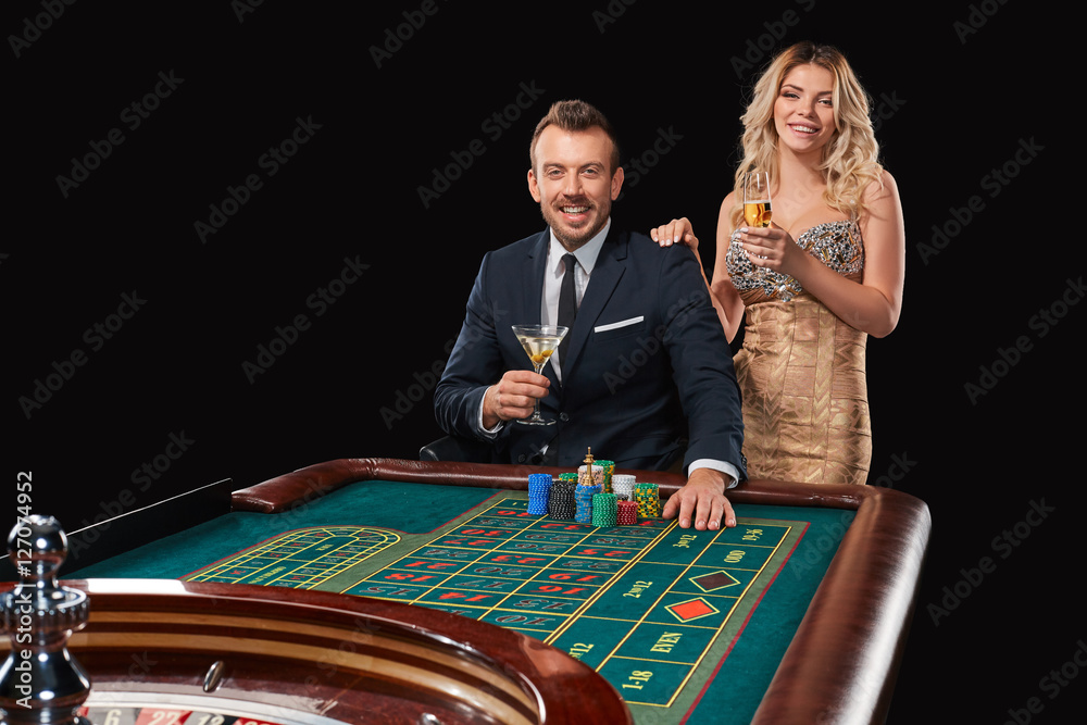 Couple playing roulette wins at the casino. Couple playing roulette wins at the casino.